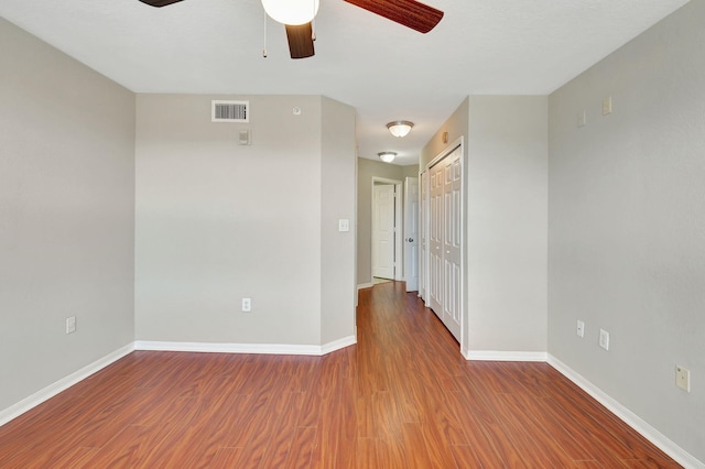 empty room featuring ceiling fan and wood-type flooring