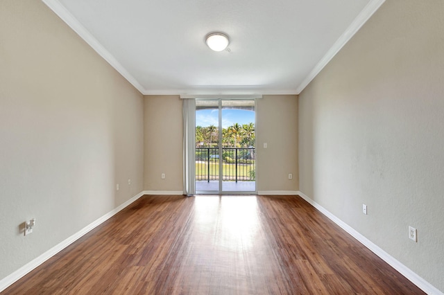 empty room with crown molding, expansive windows, and dark wood-type flooring