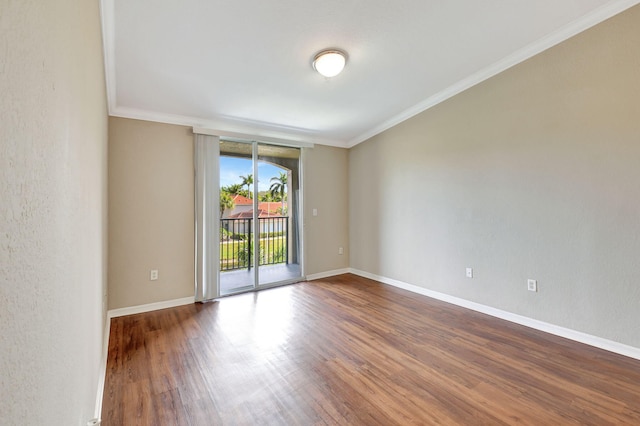 spare room with hardwood / wood-style floors and ornamental molding