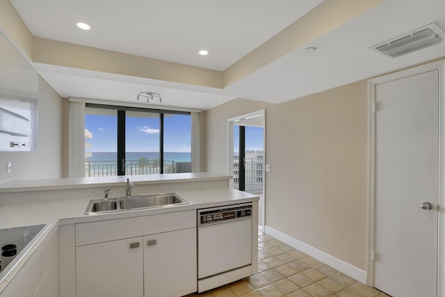 kitchen with white dishwasher, sink, black electric cooktop, a wealth of natural light, and white cabinetry