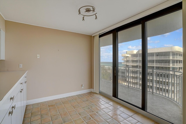 unfurnished dining area with light tile patterned floors and floor to ceiling windows