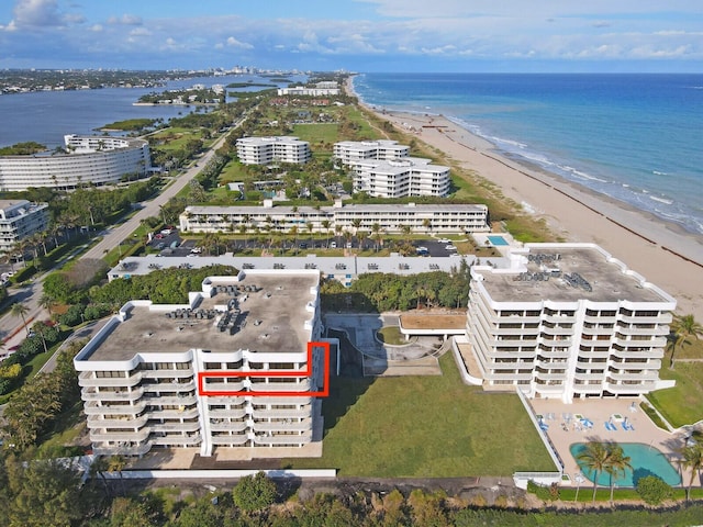 drone / aerial view with a water view and a view of the beach