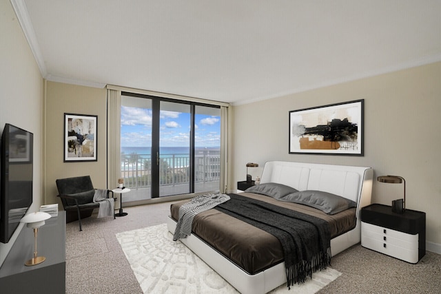 carpeted bedroom with a water view, expansive windows, and crown molding