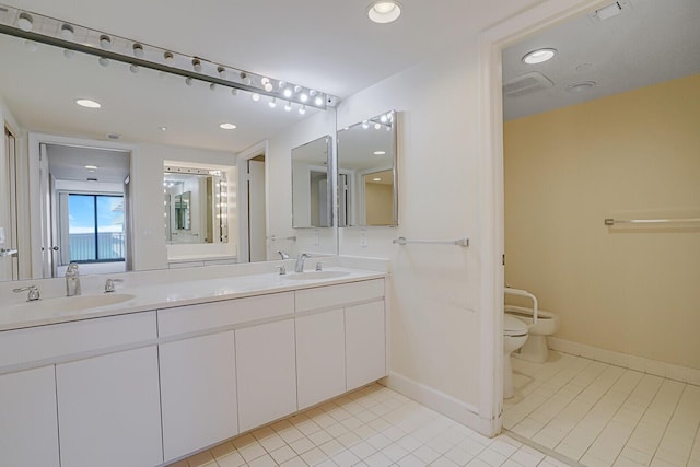 bathroom featuring tile patterned floors, vanity, and toilet