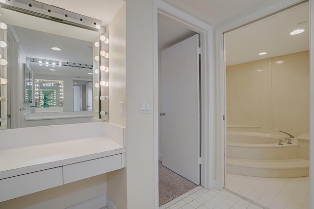 bathroom featuring tile patterned floors, a bathtub, and vanity