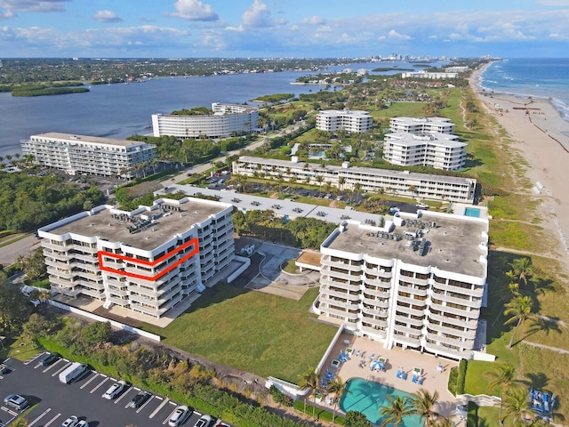 bird's eye view featuring a water view and a view of the beach