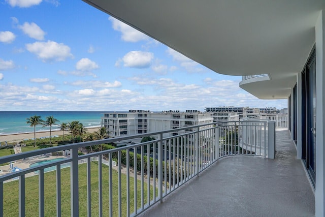 balcony with a beach view and a water view