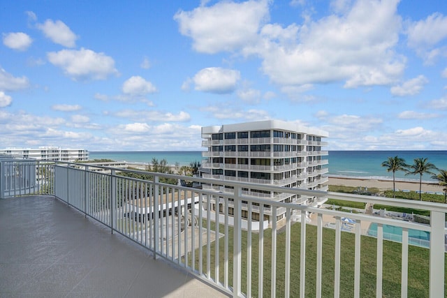 balcony featuring a beach view and a water view