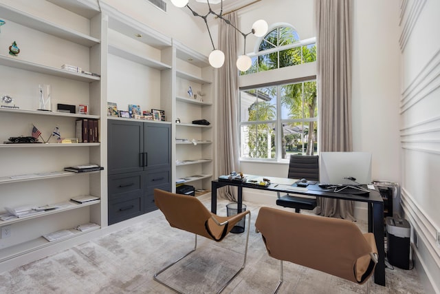 office space with visible vents, built in shelves, and a chandelier