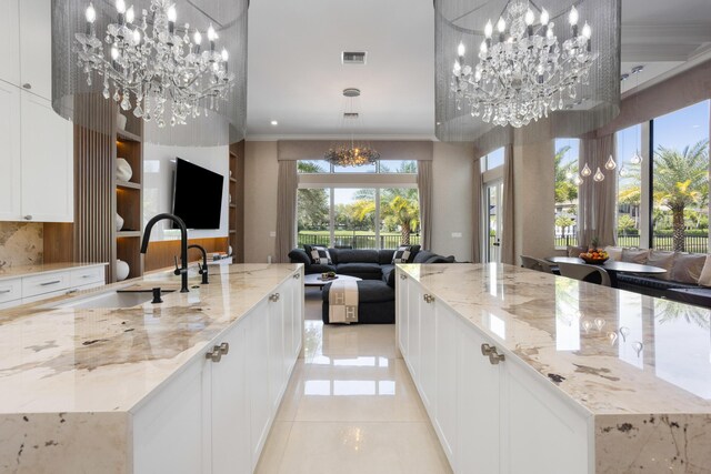 dining room featuring an inviting chandelier, light tile patterned floors, tile walls, and a wealth of natural light