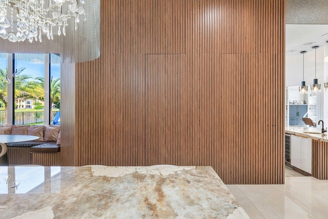 interior space with wine cooler, sink, and a chandelier