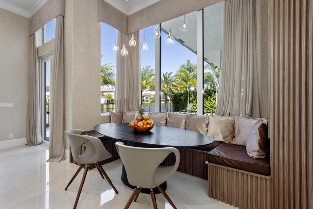 kitchen with white cabinetry, decorative light fixtures, high end stainless steel range, and a chandelier