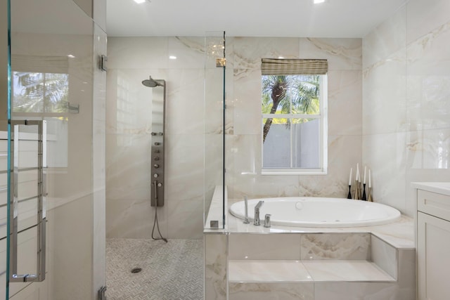 full bathroom with tile walls, a garden tub, a tile shower, and vanity