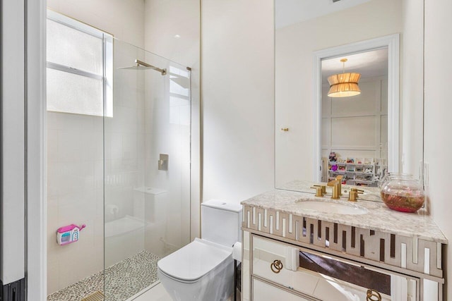 bathroom featuring vanity, an enclosed shower, and toilet