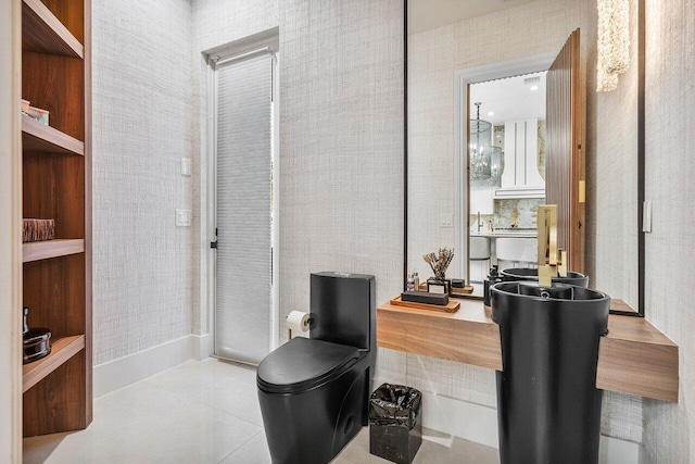 bathroom with toilet and tile patterned flooring