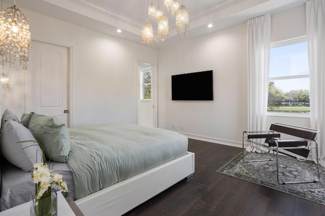 bedroom with dark wood-style floors, recessed lighting, a raised ceiling, and a notable chandelier