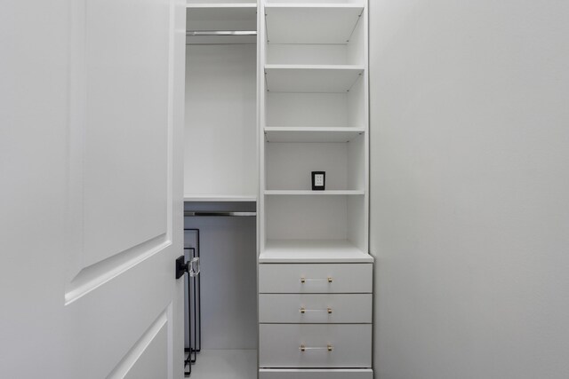 bathroom with vanity, crown molding, and a shower with door