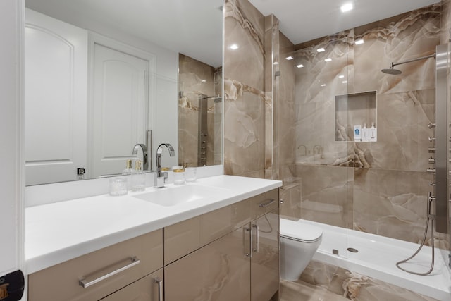 full bathroom with a stall shower, vanity, and toilet