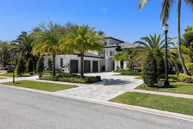 view of front of property with a garage and decorative driveway