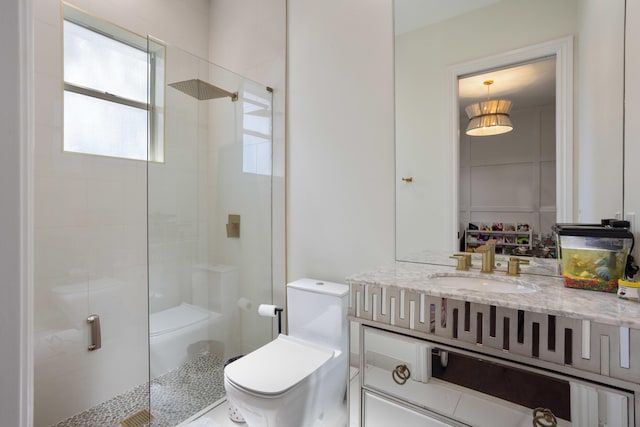 bathroom featuring a stall shower, vanity, and toilet