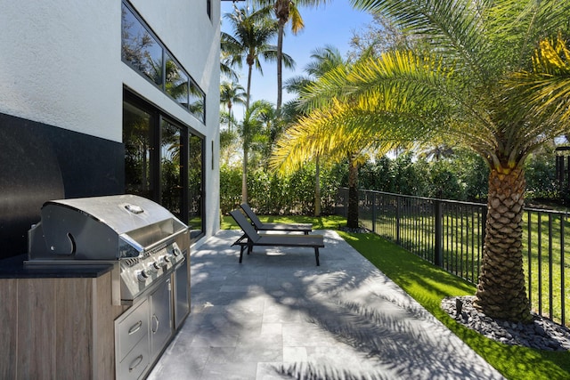 view of patio featuring fence and area for grilling