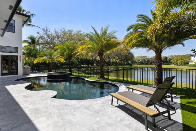 view of swimming pool featuring an in ground hot tub and a patio