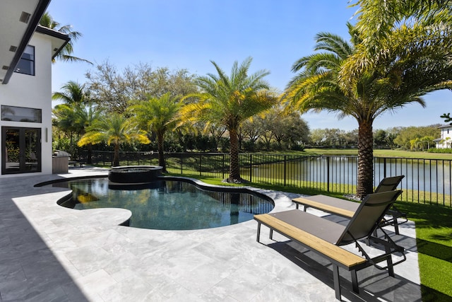 view of pool featuring a patio, a water view, a fenced backyard, and a pool with connected hot tub