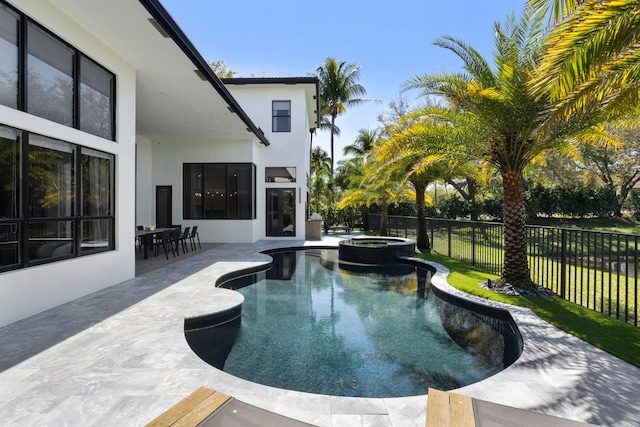 view of pool with a patio area, a fenced backyard, and a pool with connected hot tub