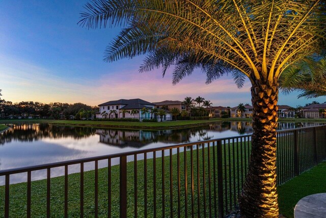 rear view of property featuring a yard and a water view