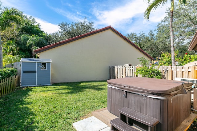 view of yard with a hot tub and a storage shed