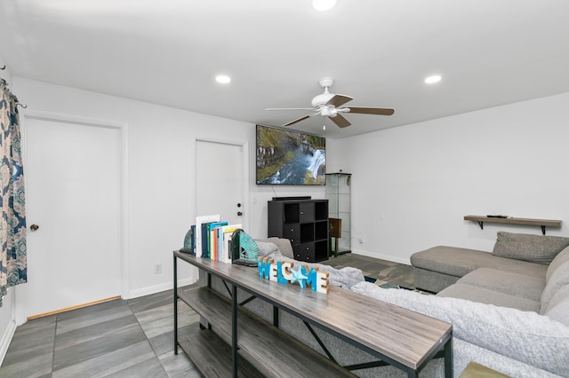 living room featuring ceiling fan and hardwood / wood-style flooring