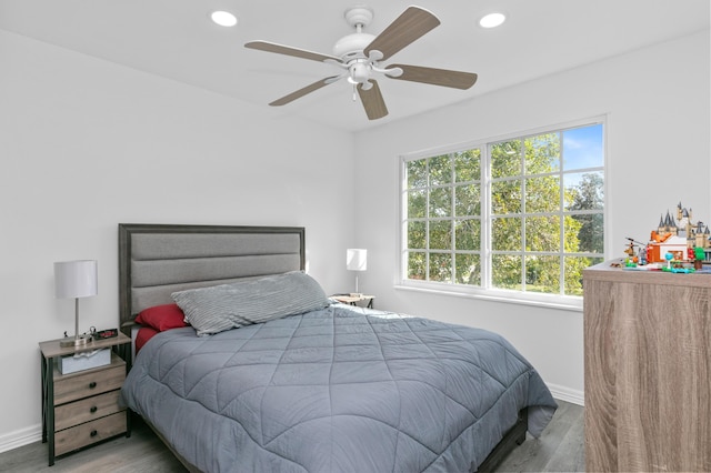 bedroom with hardwood / wood-style flooring and ceiling fan