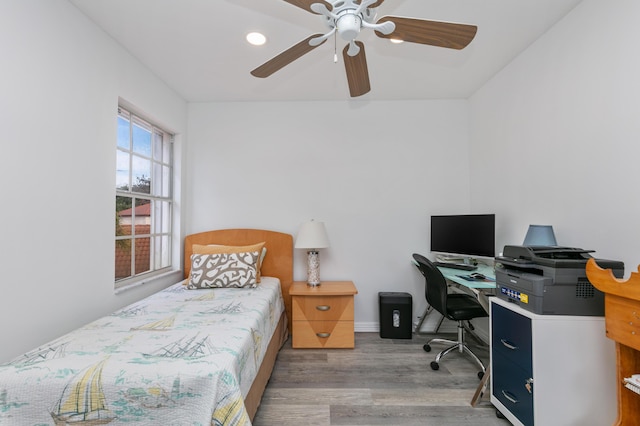 bedroom with ceiling fan and light hardwood / wood-style flooring