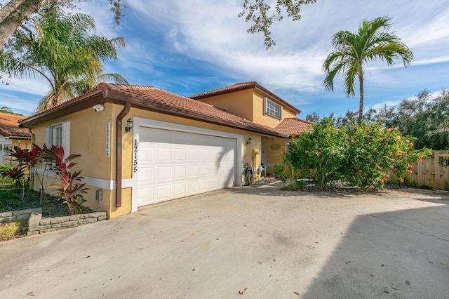 mediterranean / spanish-style home featuring a garage