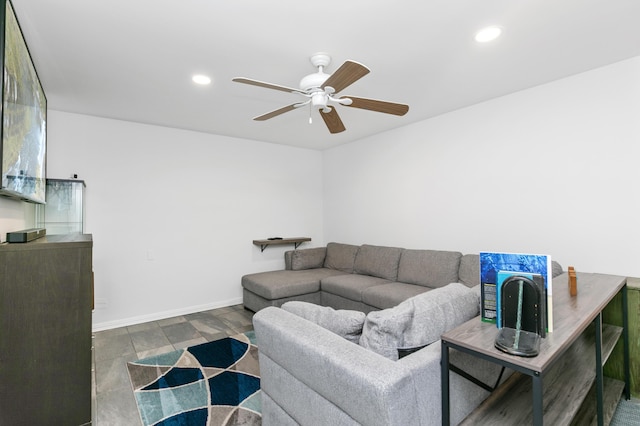 living room with ceiling fan and dark hardwood / wood-style flooring