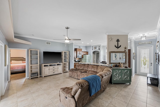 living room with ceiling fan, light tile patterned floors, and crown molding