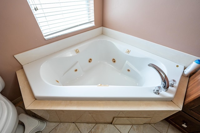 bathroom with a tub and tile patterned flooring