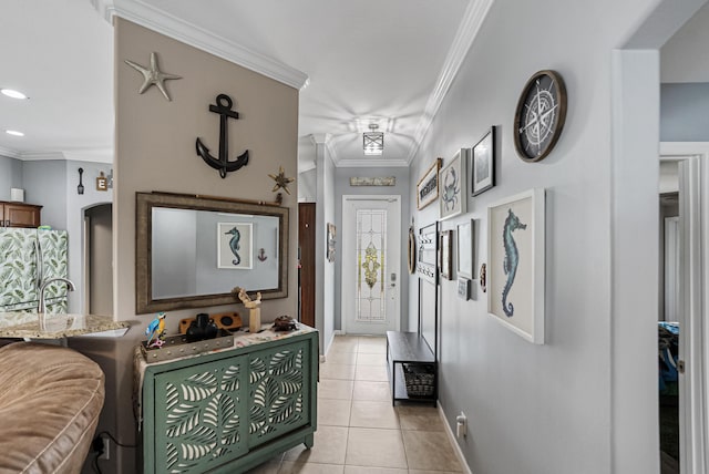 tiled entrance foyer featuring crown molding