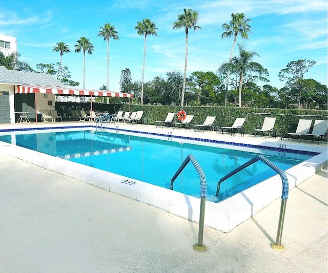 view of swimming pool with a patio