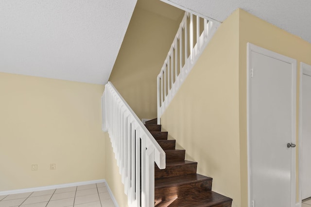 stairway featuring tile patterned flooring