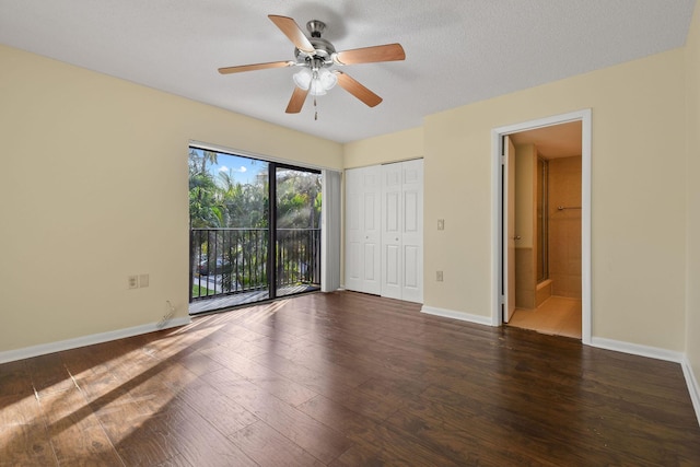 unfurnished bedroom featuring connected bathroom, access to exterior, ceiling fan, dark wood-type flooring, and a textured ceiling