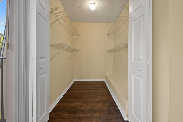 unfurnished bedroom featuring ceiling fan, a textured ceiling, and two closets