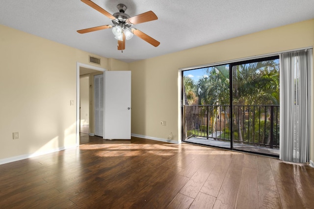 unfurnished room featuring wood-type flooring and a textured ceiling