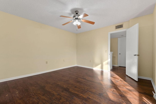 unfurnished room with ceiling fan, dark hardwood / wood-style floors, and a textured ceiling