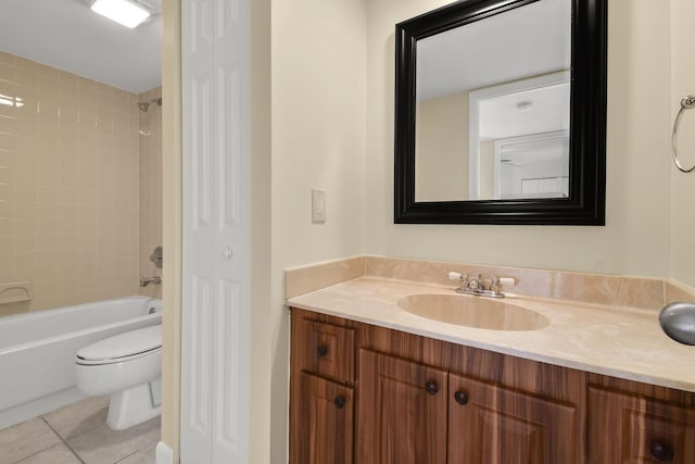 full bathroom with vanity, tiled shower / bath, tile patterned floors, and toilet