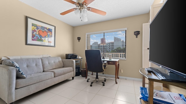 tiled home office featuring ceiling fan and a textured ceiling