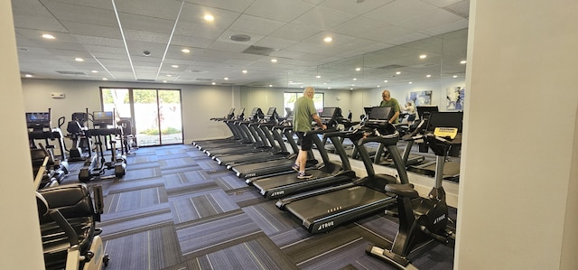 gym featuring carpet flooring and a drop ceiling