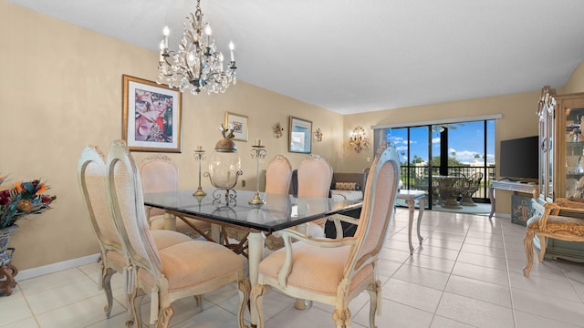 dining room with light tile patterned floors and a chandelier