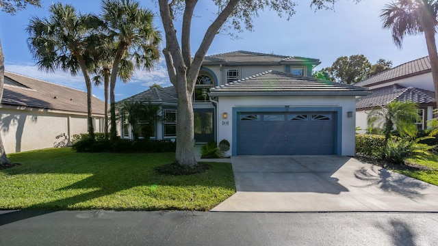 view of front of property featuring a garage and a front lawn