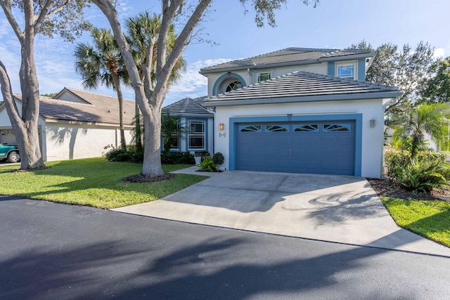 view of front of house with concrete driveway, stucco siding, a tiled roof, and an attached garage
